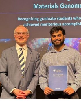 Debjyoti Bhattacharya's award photo with Prof. John Mauro